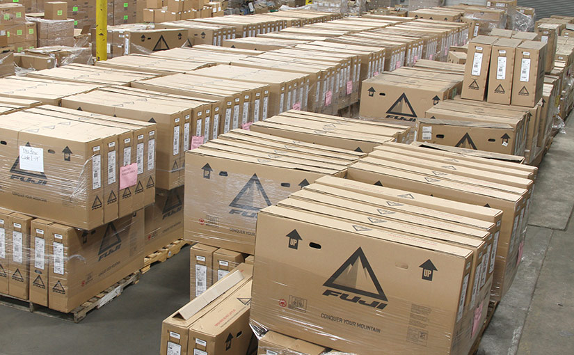 A warehouse for inventory management, filled with organized pallets of boxes.